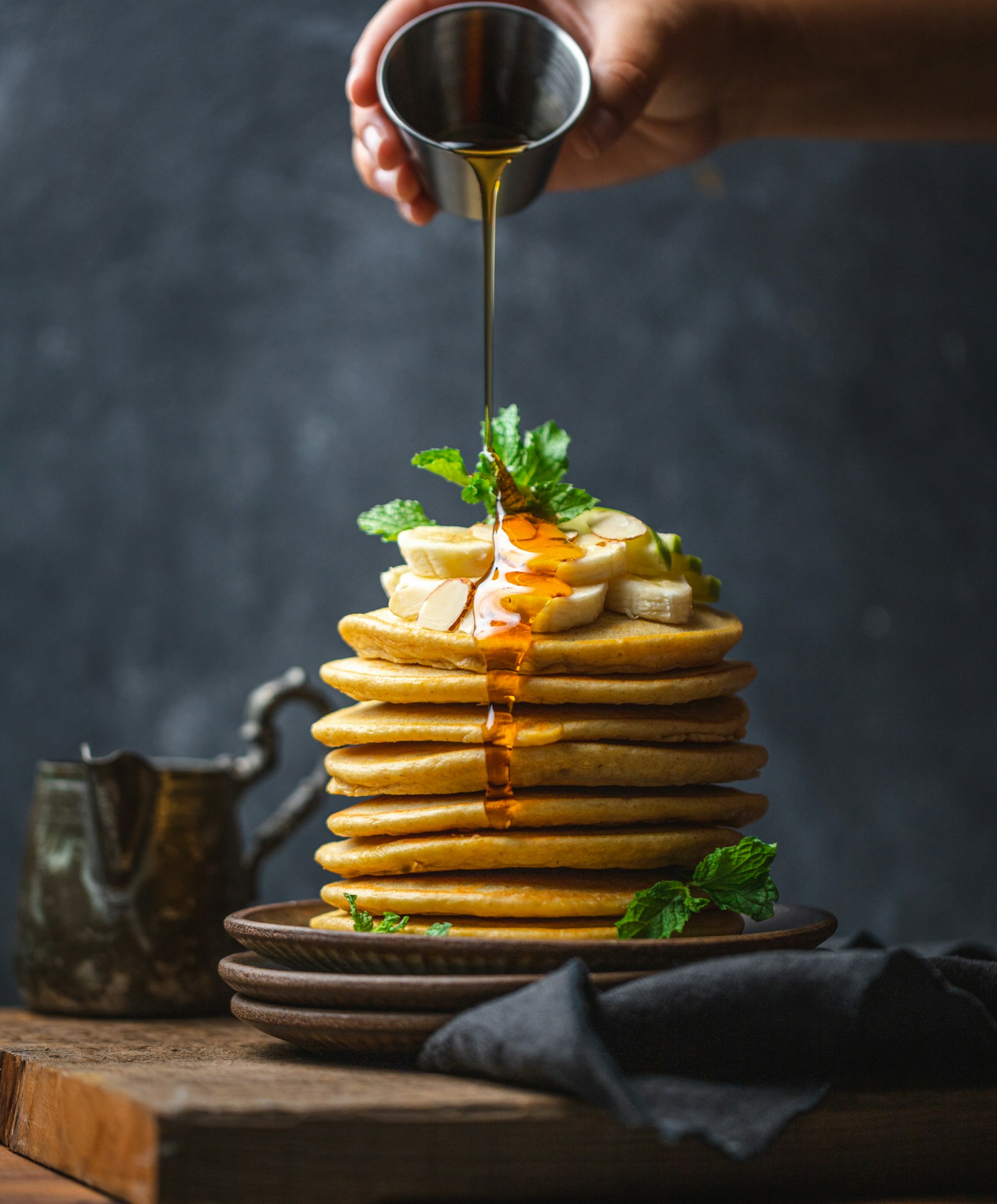 Stack of fluffy buttermilk pancakes with syrup and berries