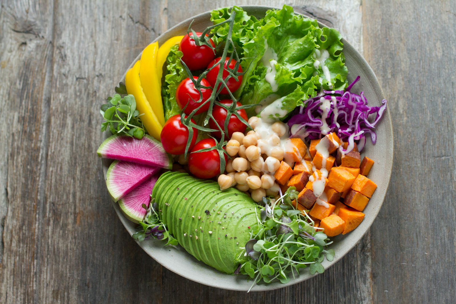 Fresh berry spinach salad in a bowl with healthy toppings